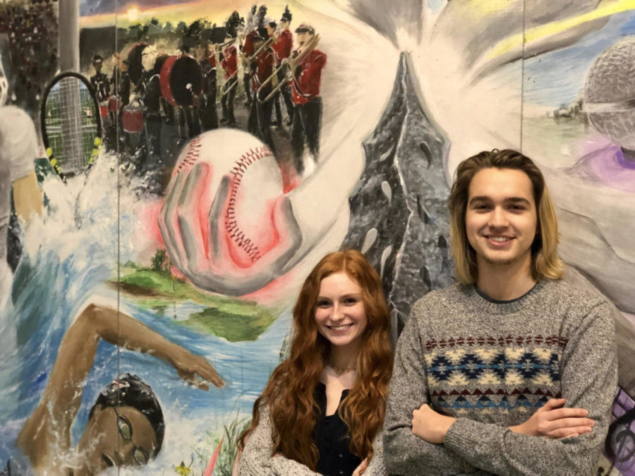 Jonah Gibson and Melanie Davis standing by the school mural